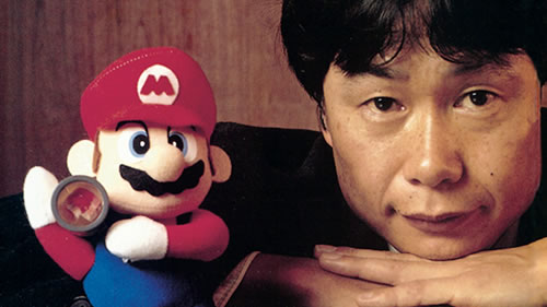 Shigeru Miyamoto and Mario figure